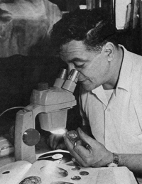 Peter J. Rosa in 1968 photo examining one of his coins.